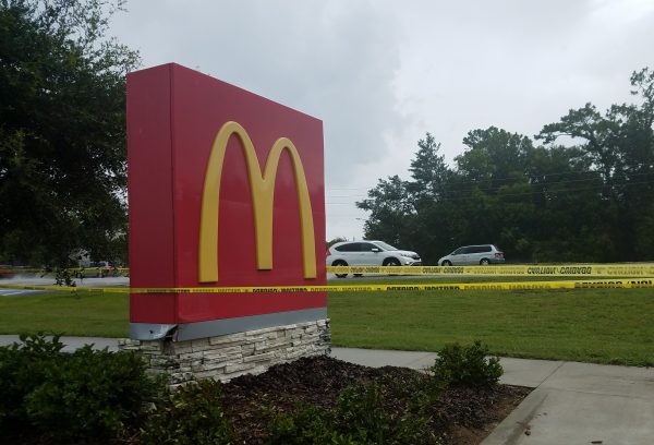 Crime scene tape is up at the damaged McDonald's sign.