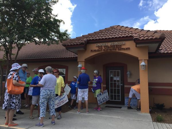 Group of Villagers come out in celebration of Medicare and Social Security's birthdays in front of Congressman Webster's office.