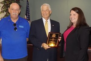 State Rep. Don Hahnfeldt, center, was honored by the Florida League of Cities. He is flanked by Mayor Jim Richards and Amber Hughes.