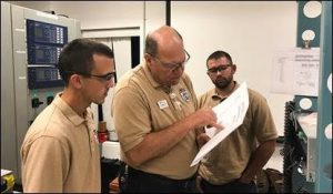 Bob Seigworth, director/program manager of LSSC Energy Programs, center, works with two Relay Tech Students as they design and build a protective relay as part of their capstone project.