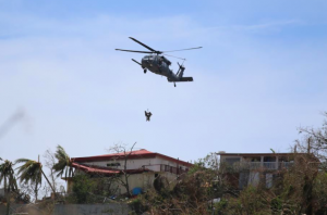 A U.S. Navy search and rescue helicopter team operates on St. Thomas.