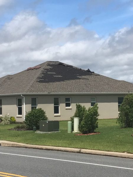 Roof shingles torn from home in Village of Dunedin