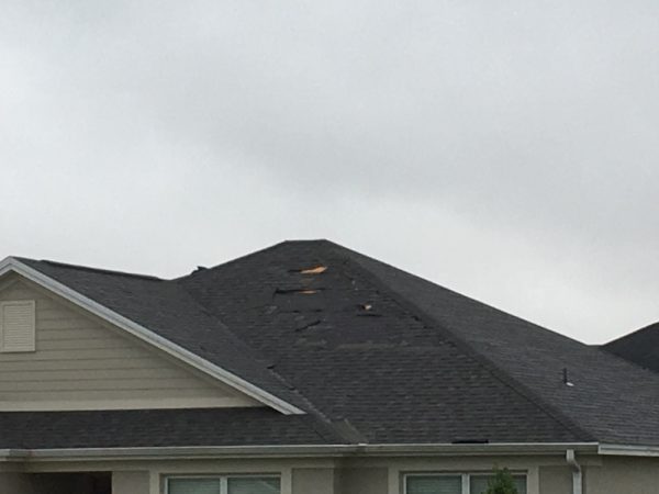 Roof shingles torn from home in Village of Lake Deaton
