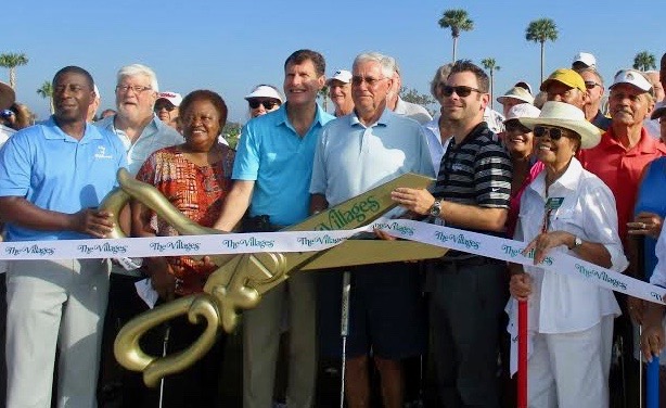 Wildwood Mayor Ed Wolff, center, mans the scissors at the ribbon cutting. He is flanked by Gary Lester of The Villages and Wildwood City Manager Jason McHugh