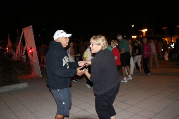 Dave and Judy Quattrone dancing at tree-lighting ceremony at lake Sumter Landing