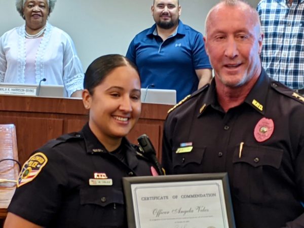 Office Angela Velez left was honored by Wildwood Police Chief Randy Parmer