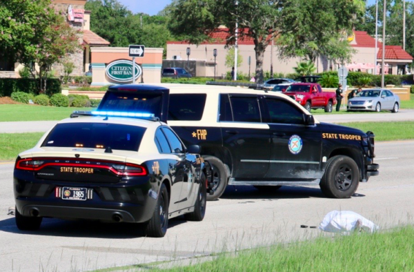 The body was draped in a white sheet Monday morning near UF Health The Villages Hospital