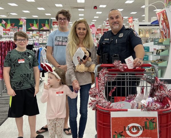 Lady Lake officer Austin manned the shopping cart for Clayton Evie and Jackson High as they completed their Christmas shopping.