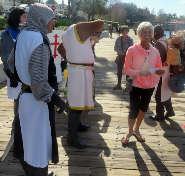 Villager Laura Kernbauer strolls past some Spamalot Knights while out for a sunny walk at Lake Sumter