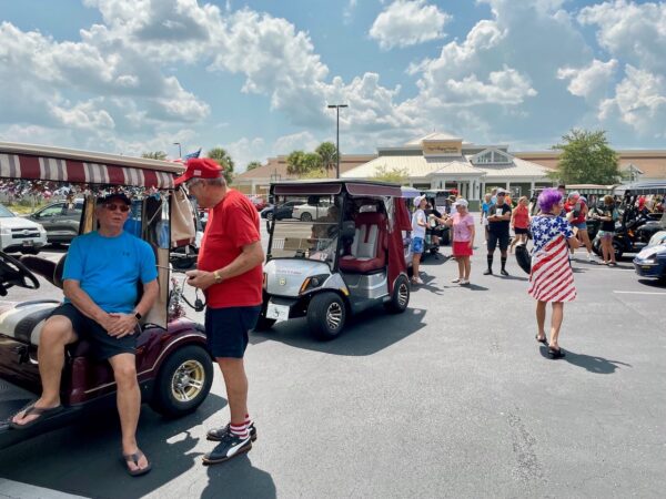 Participants chatted before the start of Saturday's golf cart rally