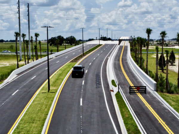 The bridge over the Florida Turnpike includes four lanes of automobile traffic and two lanes of golf cart traffic