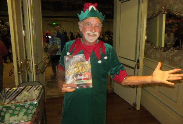 Peter Ely was an elf handing out flameless candles to the audience for Carols by Candlelight