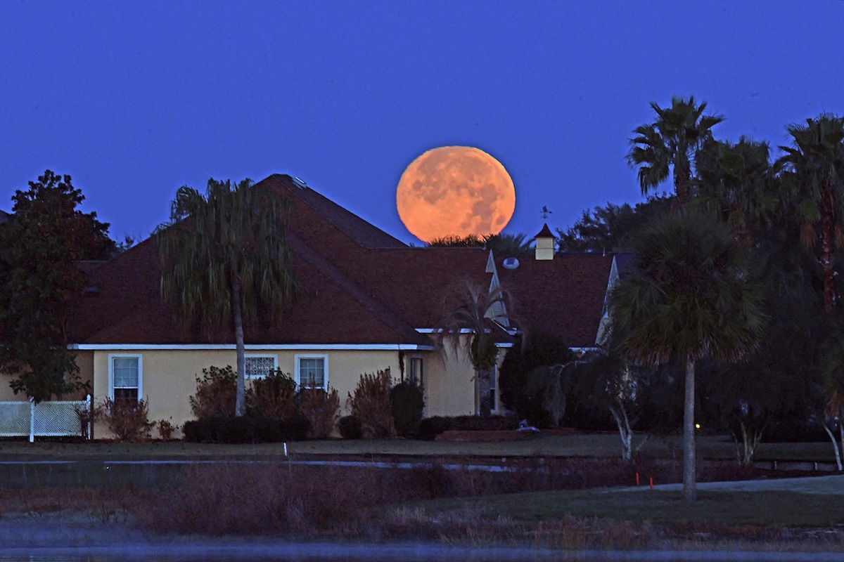 Full snow moon setting across Lake Sumter Landing