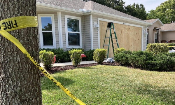 The garage was boarded up at the home on Lester Drive after the crash hours earlier