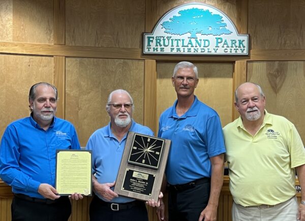 Mayor Chris Chesshire presents Commissioner John Gunter with an award for thityone years service along with his Vice Mayor Patrick DeGrave and and commissioner John Mobilian