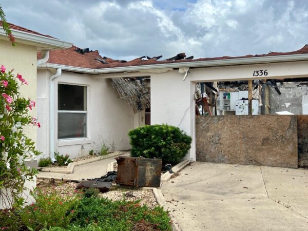 Neighbors are concerned about debris at this house damaged by a fire sparked by lightning