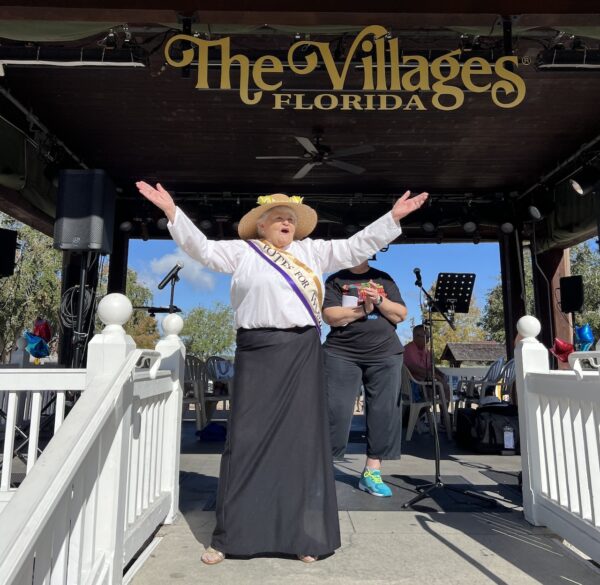 Dressed as an early suffragist, Dorothy Dobbs addressed the crowd from the pavilion at Lake Sumter Landing.