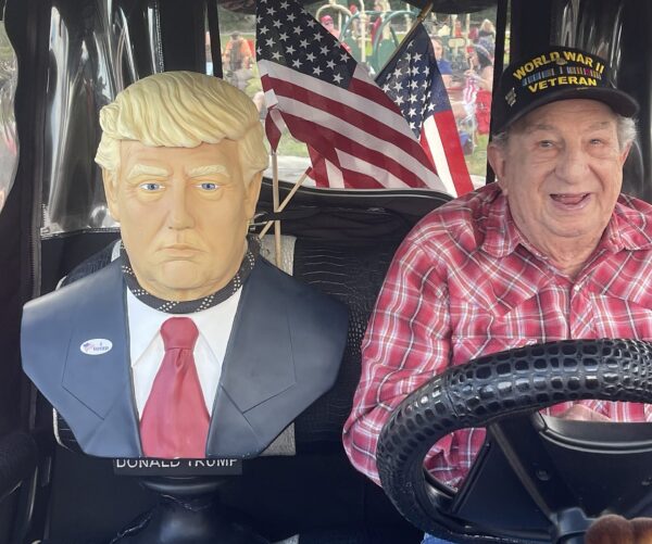 Irving Locker with a staue of Donald Trump