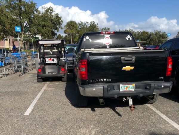 This pickup and a golf cart were crowded in near the shopping carts at Walmart at Buffalo Ridge Plaza