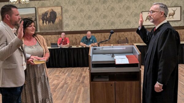 Todd Coon, left, was sworn in by Judge Paul Militello.