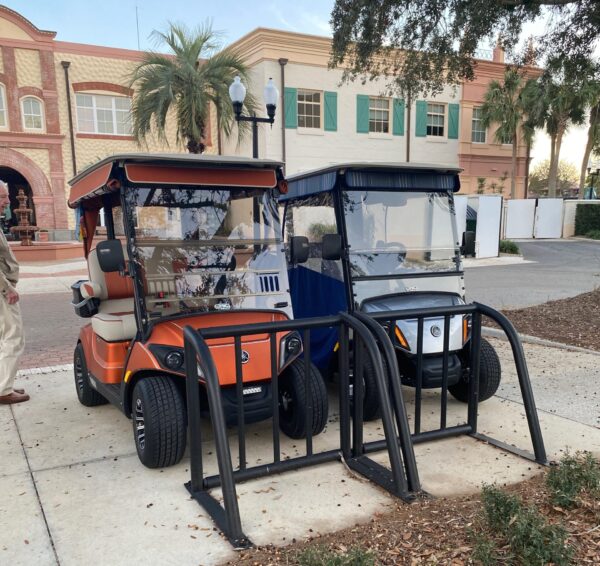 These golf carts were parked in racks designed for bicycles at Spanish Springs